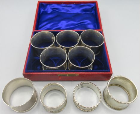 George V silver cased set of five matching monogrammed napkin rings by Mappin &amp; Webb Ltd, Birmingham, 1916 and four other