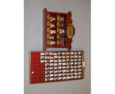 A collection of Steiff metal figures together with a quantity of ceramic thimbles, both in display cases
