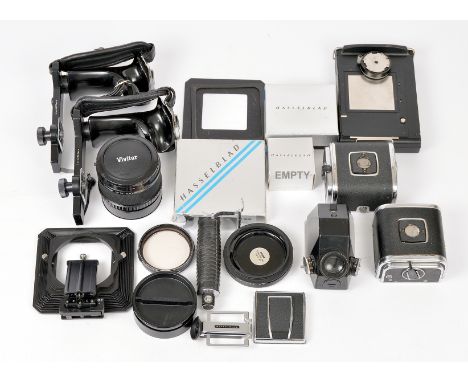 Good Selection of Hasselblad Accessories, inc Vivitar x2 Converter. Also grips, 2 roll film backs, Polaroid back etc