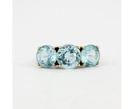 A 925 silver ring set with three large round cut blue topaz, ().
