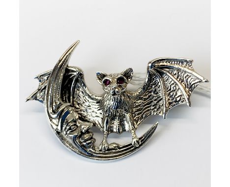 A 925 silver pendant / brooch in the form of a bat with ruby eyes.