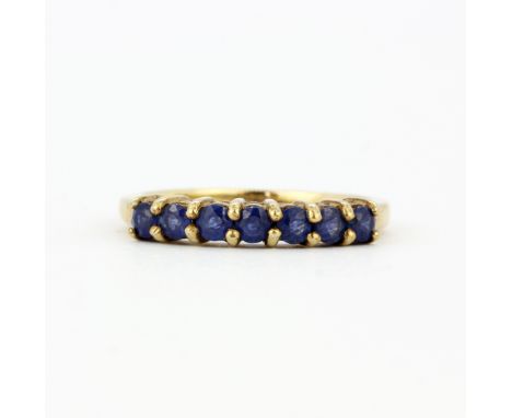 A hallmarked 9ct yellow gold ring set with round cut sapphires, (N).