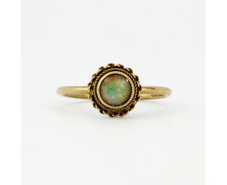 A hallmarked 9ct yellow gold opal set solitaire ring, (K.5).