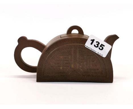 A Chinese Yi Xing terracotta teapot, signed to base. Spout to handle L. 18cm, H. 9cm.