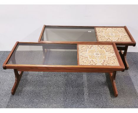 A pair of 1970's teak ceramic tile and smoked glass coffee tables, 121 x 50 x 44cm.