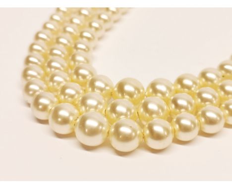 A pretty, vintage three row synthetic pearl necklace on a 10ct white gold clasp.