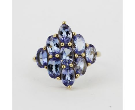 A hallmarked 9ct yellow gold ring set with large oval cut tanzanites, (S).