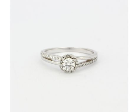 An 18ct white gold halo ring set with brilliant cut diamonds and diamond set shoulders, centre stone approx. 0.33ct, clarity 