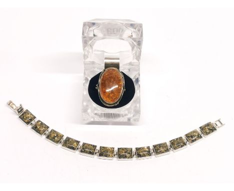 A silver and amber bracelet with a silver and amber ring.