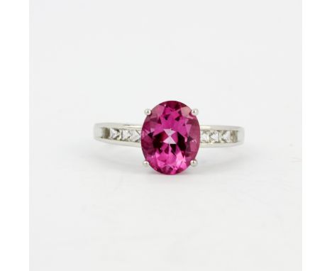 A 925 silver ring set with a large oval cut pink topaz and white topaz set shoulders, (O.5).