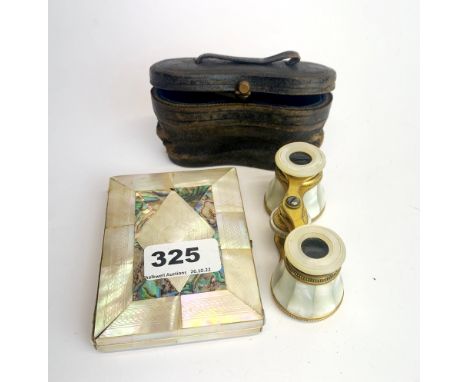 A cased pair of 19th century gilt brass and mother of pearl opera glasses with a mother of pearl decorated visiting card case