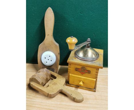 A vintage coffee grinder, butter roller and lemon squeezer.