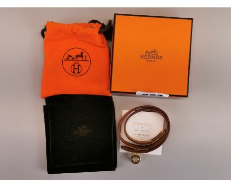 A boxed Hermes leather and gilt bracelet.