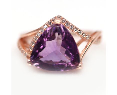 A rose gold on 925 silver ring set with a large trillion cut amethyst and white stones, (L.5).