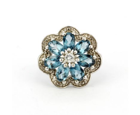 A large 925 silver flower ring set with oval cut swiss blue topaz and white topaz, (O).