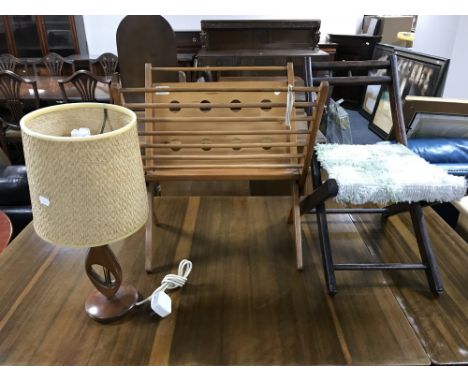 A mid twentieth century teak magazine rack, together with a teak table lamp and shade and a children's folding chair 