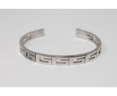 An 18ct gold diamond set bangle by Gucci, 28.2g (Cost £2,800 new) *Ensuite to the following lot