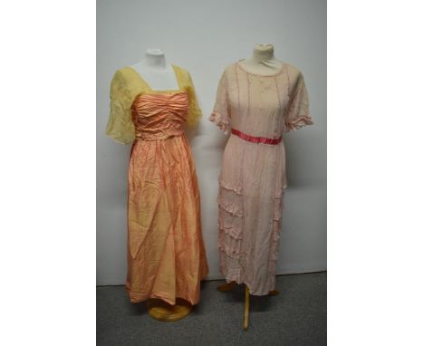 Two early 20th century dresses, comprising lawn cotton dress with frilled skirt and ladder work to bodice and iridescent peac