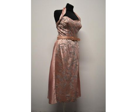 A 1950s pink satin Susan Small model halterneck dress, having extensive braiding and diamante accents throughout, included is