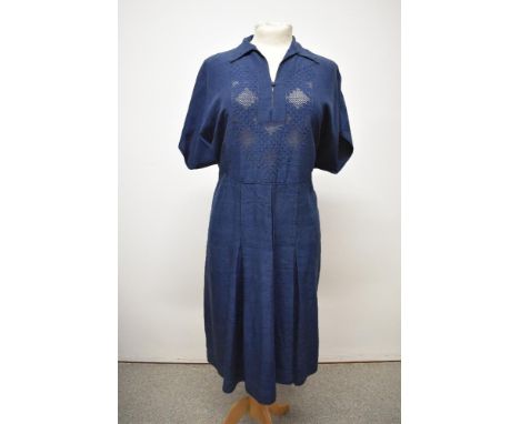 A 1940s navy blue day dress having unusual textured design and ladder work to bodice, brass side zipper and pleats to skirt, 