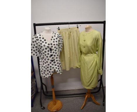 A 1980s black and white Yves Saint Laurent jacket and a mint green Valentino Boutique skirt and blouse set.
