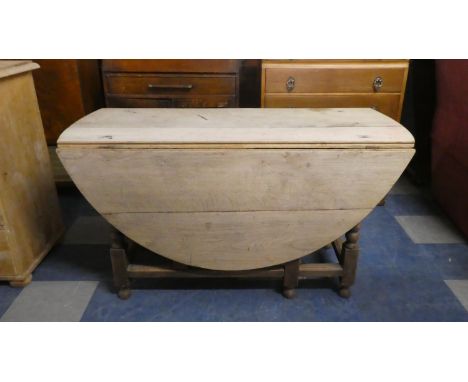 A Bleached Oak Gate Leg Drop Leaf Dining Table with Oval Top, 127cm Long 