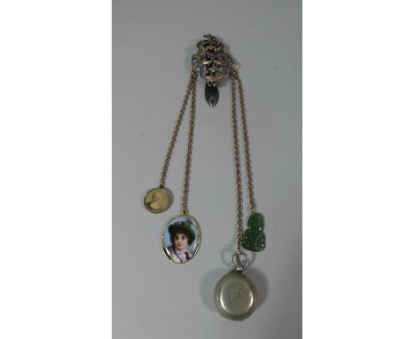 A Yellow Metal and Steel Chatelaine with Attachments to Include Jade Tiki, Painted Porcelain Portrait, Broken Sovereign Holde