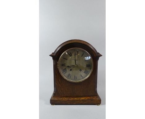 An Edwardian Oak Mantle Clock, the Dial Inscribed Pleasance and Harper, Shrewsbury, with Pendulum and Key but Movement Needs 