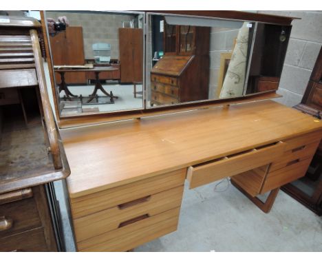 A vintage teak dressing table, labelled Uniflex