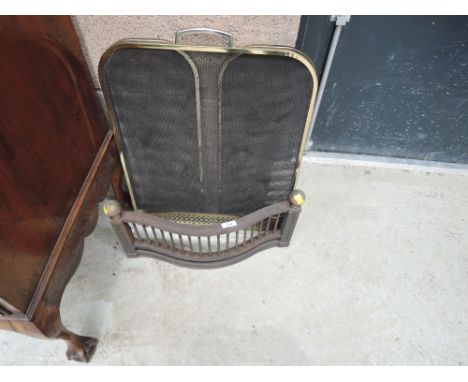 A vintage cast fire front and modern brass fireguard