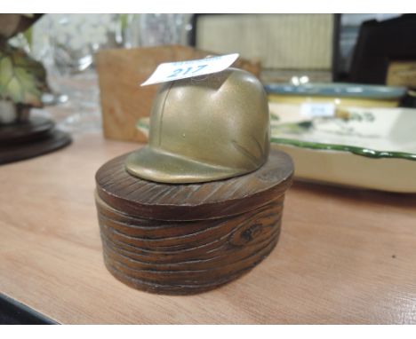 a small trinket holder with jockey helmet cover