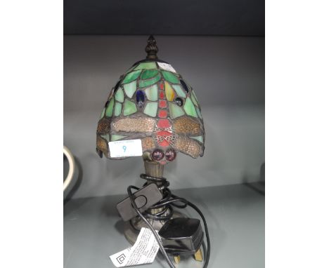 A tiffany style table lamp with dragonfly design and leaded light