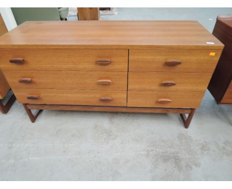 A vintage teak sideboard having three long and three short drawers