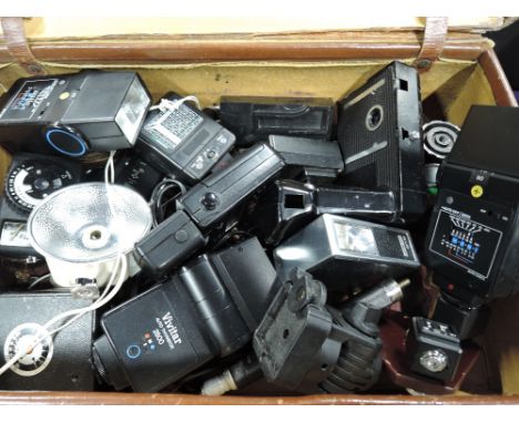 A case of various flash shoes, light meters etc 