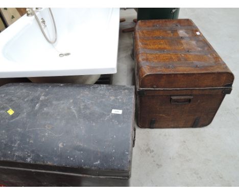 A vintage dome top tin travel trunk