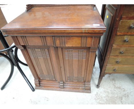 A vintage singer sewing machine in cabinet with fold out mechanism