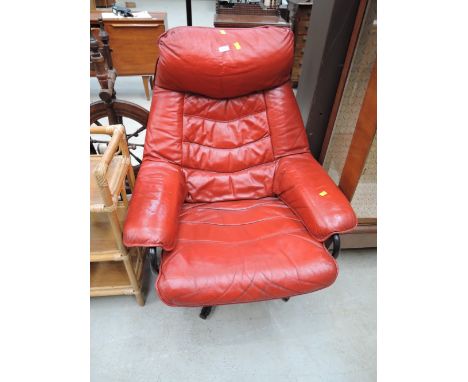 A vintage red leather recliner chair