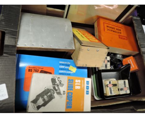 A box of photography and development equipment, Including Ilford Film Strip printer, a home made light box, a Baeuerle timer,