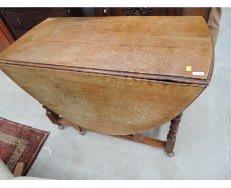 An early to mid 20th Century oak twist gate leg dining table