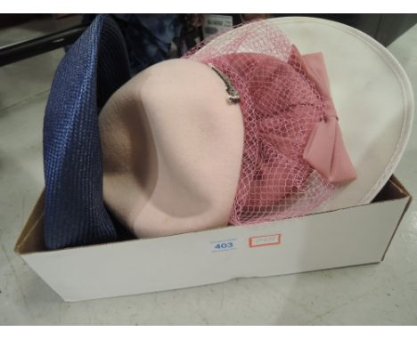 Four vintage hats in various styles and colours.