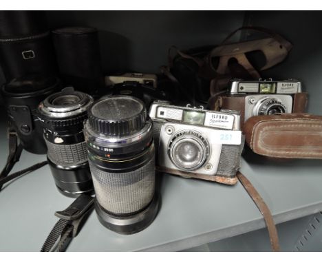 Four cameras and two lenses including two Ilford Sportsman, a Kodak Instamatic 25 and a Tamashi FMD, a Sigma Zoom 4 and a Viv