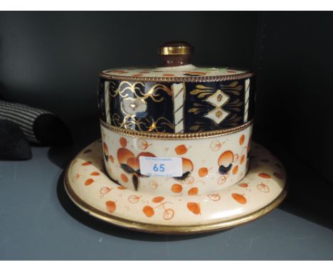 A heavy set ceramic cheese wedge or lidded dish with Imari ware palette 