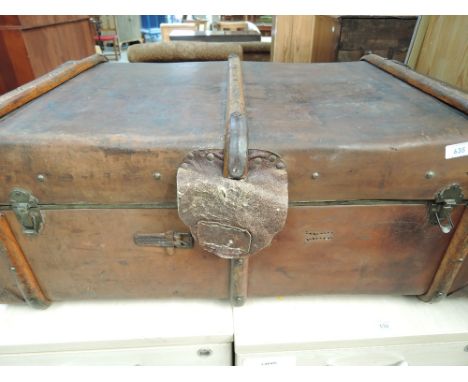 A vintage leather travel trunk, bearing monogram ELL