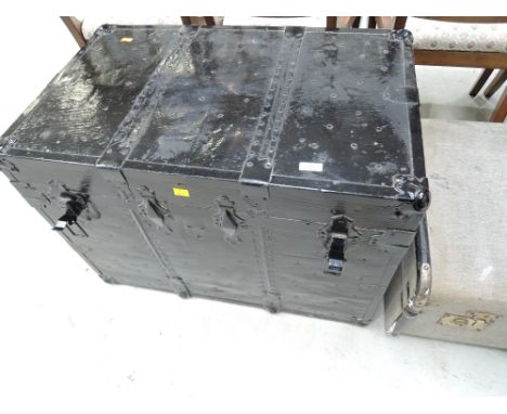 A vintage black painted travel trunk
