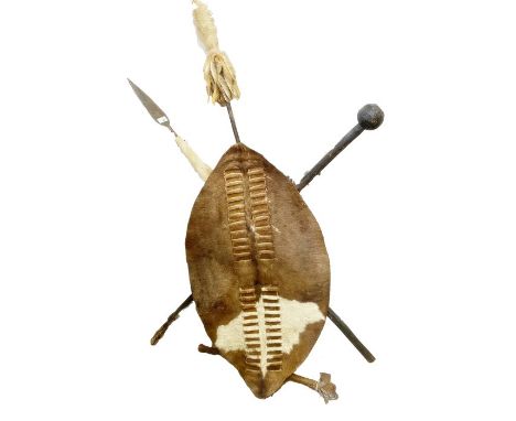 Reproduction Zulu shield and weapon display signed by South African actor Henry Cele with inscription to the back reading 'Be