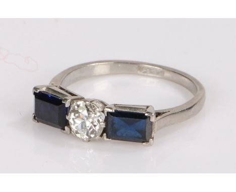 Art Deco platinum sapphire and diamond set ring, the central diamond at an estimated 0.50 carat flanked by a baguette cut dia