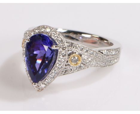 18 carat white gold tanzanite and diamond set ring, the central pear cut tanzanite at 3.54 carats with a diamond surround, wi