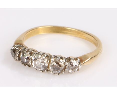 18 carat gold diamond set ring, with a row of five diamonds to the head, ring size Q