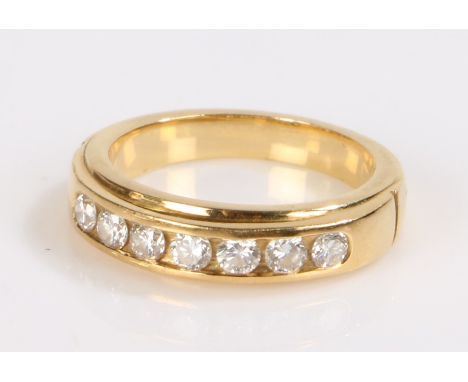 Diamond set ring, the ring with a row of seven round cut diamonds totalling 0.54 carat, set to a yellow metal shank, ring siz