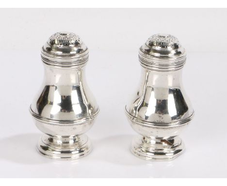 Pair of George VI silver pepperettes, London 1940, maker JCL, with domed Celtic style covers above bulbous bodies, raised on 